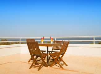 Table and two cocktails on the sky background