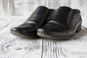 Male black shoes on white wooden background