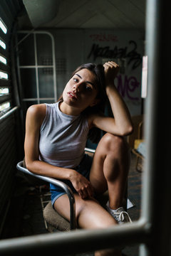 Woman sitting in decayed house