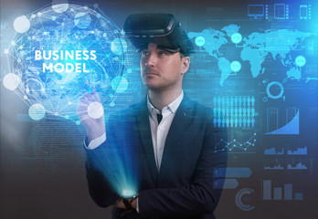 Business, Technology, Internet and network concept. Young businessman working on a virtual screen of the future and sees the inscription: Business model