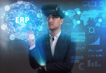 Business, Technology, Internet and network concept. Young businessman working on a virtual screen of the future and sees the inscription: ERP