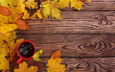 Autumn leaves and cup of coffee