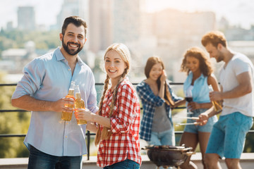 Group of friends having barbecue party on the roof