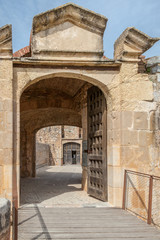 a entry gate to the fort de Salses in France on a sunny day
