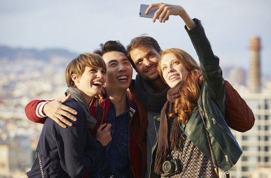 Happy Young Woman Taking Selfie With Friends