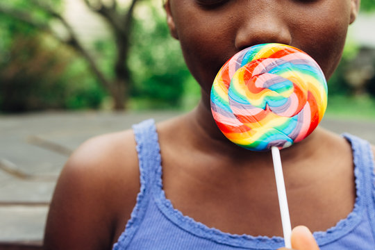 African American girl with rainbow lollipop