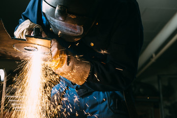 Metal worker cutting plate of steel with plasma cutter