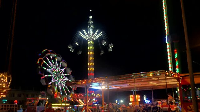 Attraction night carousel. nightlife Carnival ride in game action at night