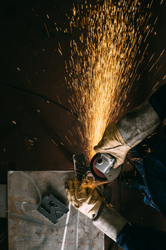 Metal worker with angle grinder