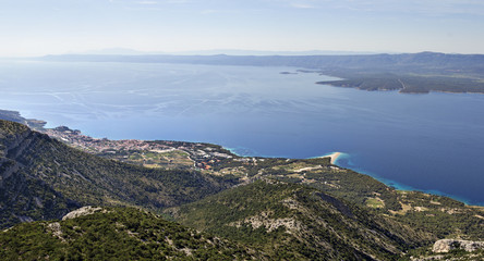 Fototapeta premium Touristic village Bol on island Brac and Golden cape (Zlatni Rat) famous beach, viewed from Vidova Gora mountain