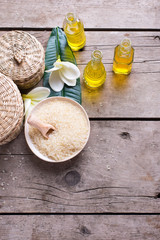  Bottles with essential aroma oil, sea salt and tropical flowers plumeria