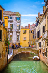 Fototapeta na wymiar Traditional narrow canal with gondolas in Venice, Italy