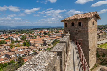 Fototapeta premium part of Medieval fortified city of Carcossone with trees and blue sky