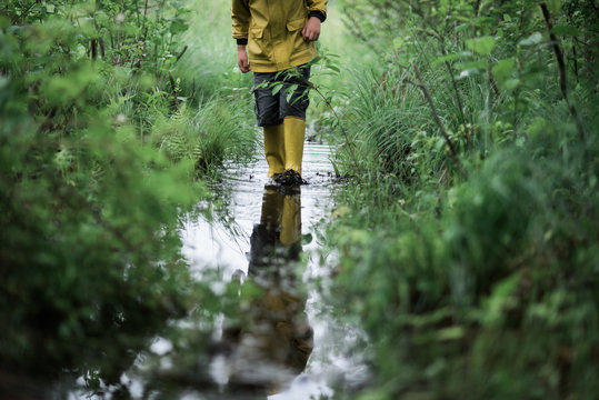 little boy on walk in a flooded path
