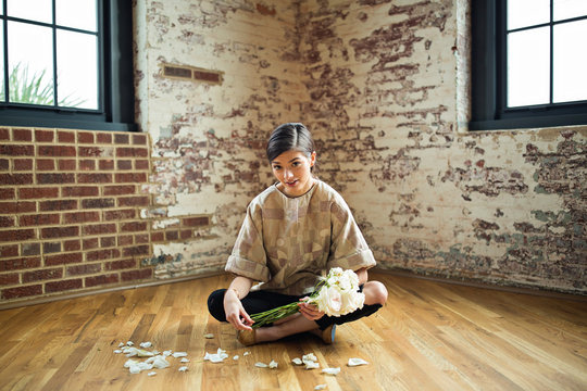 Woman picking petals off roses