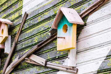 birdhouse on an old wooden house painted in different colours