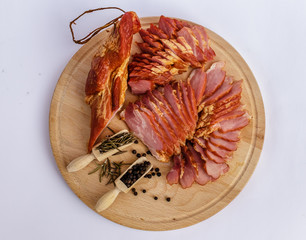Smoked ham,black pepper whole and dried rosemary on wooden plate