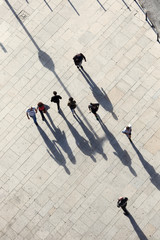 Abstract people and there shadows on city street. Sunny summer day