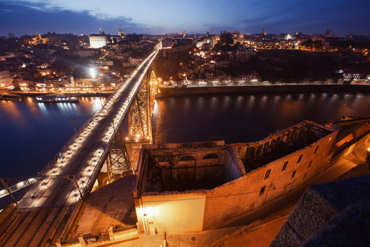 Night view on European city with bridge and river. Porto, Portugal