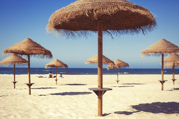 Beach umbrella on sunny day with sea background