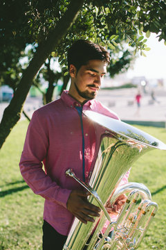 Outdoor Portrait of musician with tuba wind musical instrument