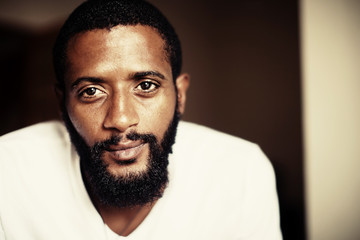 Fototapeta premium Portrait of handsome man with beard. Mixed race black skin