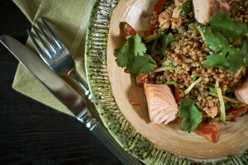 baked salmon with herbs. Green buckwheat and vegetable salad