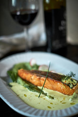 Baked trout with sauce and broccoli