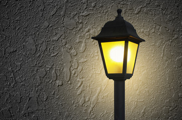 Grey wall background with street light at the front