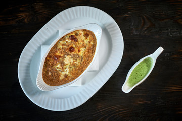 Baked trout with sauce and broccoli