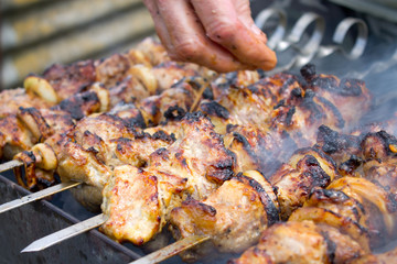 Grilled kebab cooking on metal skewer closeup