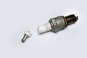 broken spark plug on white background