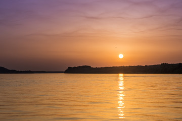 Beautiful unreal abstract colorful sunset on the Danube river