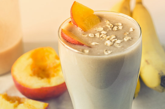Fruit Smoothies. Milkshake with peach and oatmeal. Peach banana smoothies. Delicious and healthy breakfast