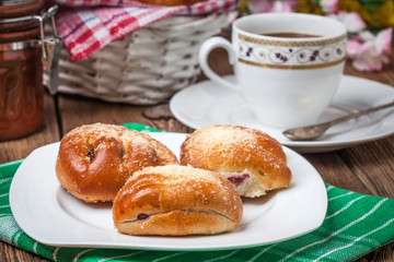Buns with berries on a wooden table.