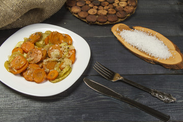 Fresh fried hot vegetables with meat and spices on the table