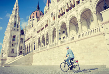 Fototapeta na wymiar Young man riding bicycle in Budapest, Hungary