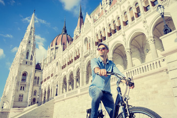 Young man riding bicycle in Budapest, Hungary