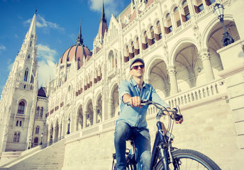 Fototapeta na wymiar Young man riding bicycle in Budapest, Hungary