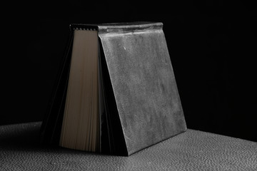 Hardcover book in black background