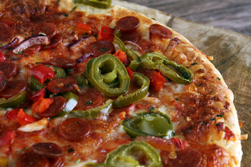 Hot pizza slice with melting cheese on a rustic wooden table. Italien food concept