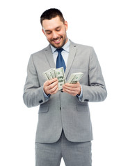 smiling businessman counting american dollar money