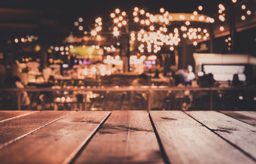 Empty of wood table top with blurred light gold bokeh abstract background.For montage product display or key visual layout