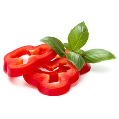 Red sweet bell pepper slices and basil leaves isolated on white background cutout