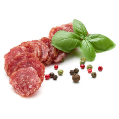 Salami smoked sausage slices, basil leaves and peppercorns isolated on white background cutout