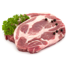 Raw pork neck chop meat with parsley herb leaves and peppercorn spices garnish isolated on white background cutout