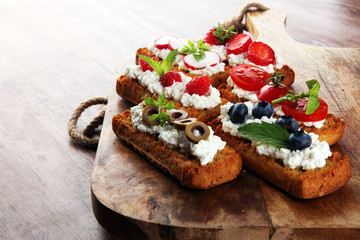 Bread Brushetta or authentic traditional spanish tapas set for lunch table. Sharing antipasti on party or summer picnic time over wooden rustic background.