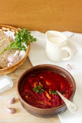 A traditional dish of Russian and Ukrainian cuisine - borsch. Soup with beets, meat, potatoes and beans. Served with sour cream and garlic.