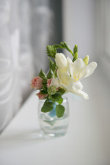 A boutonniere in a glass shot glass