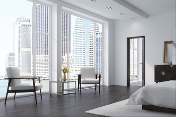 White bedroom with two armchairs